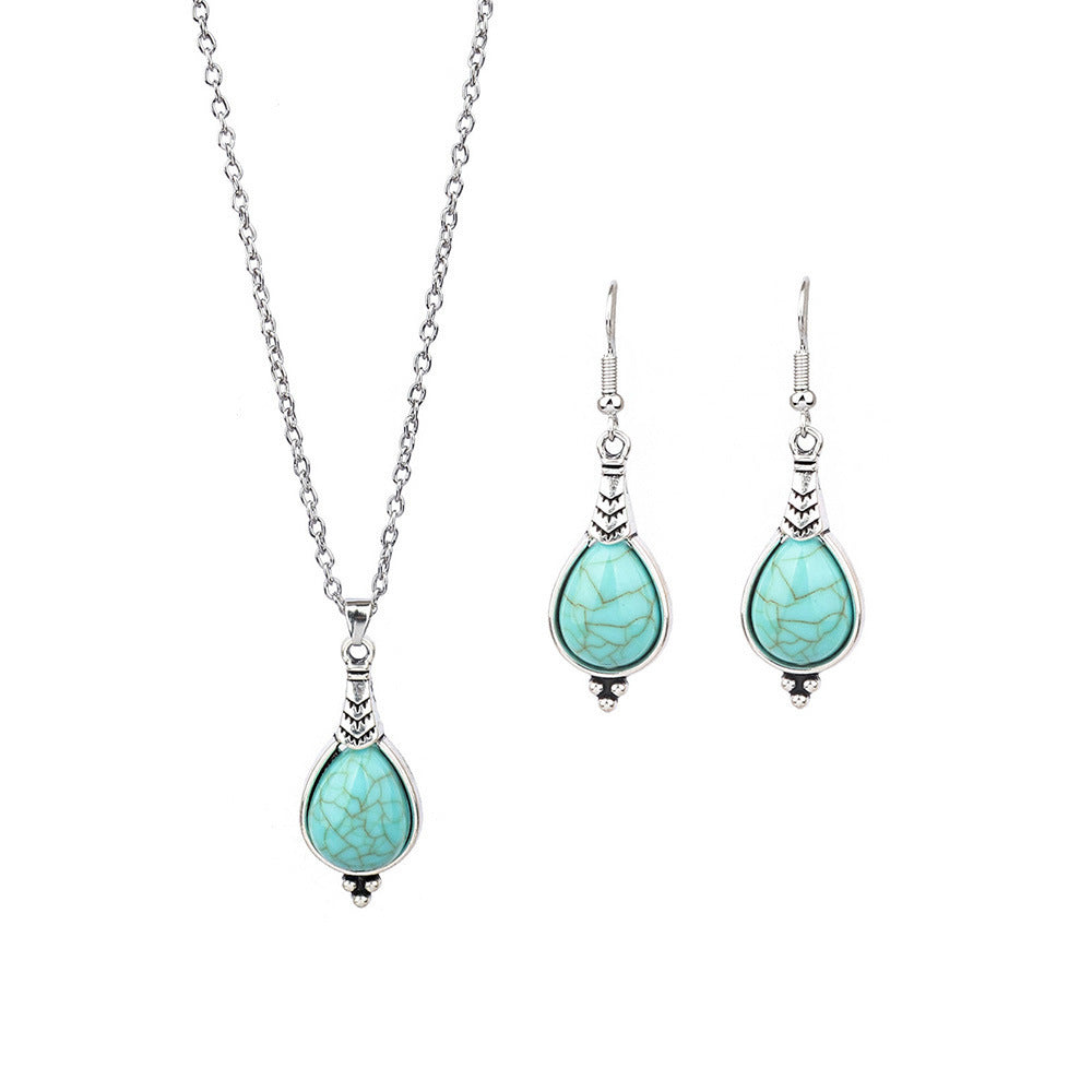 Turquoise teardrop necklace and earrings on a white background