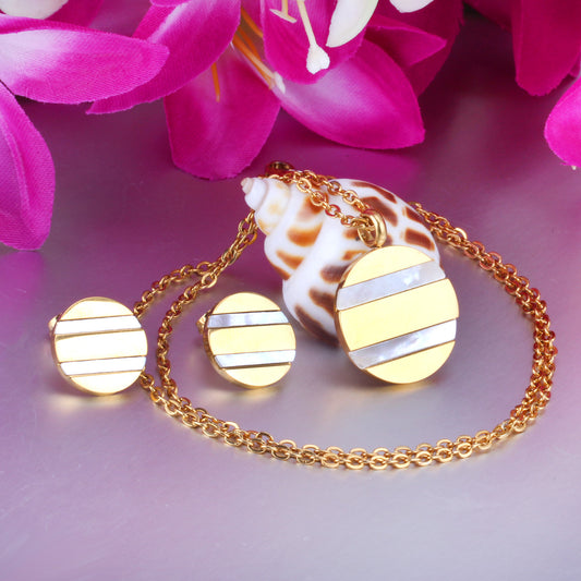Gold necklace with round pendants on a pink floral background