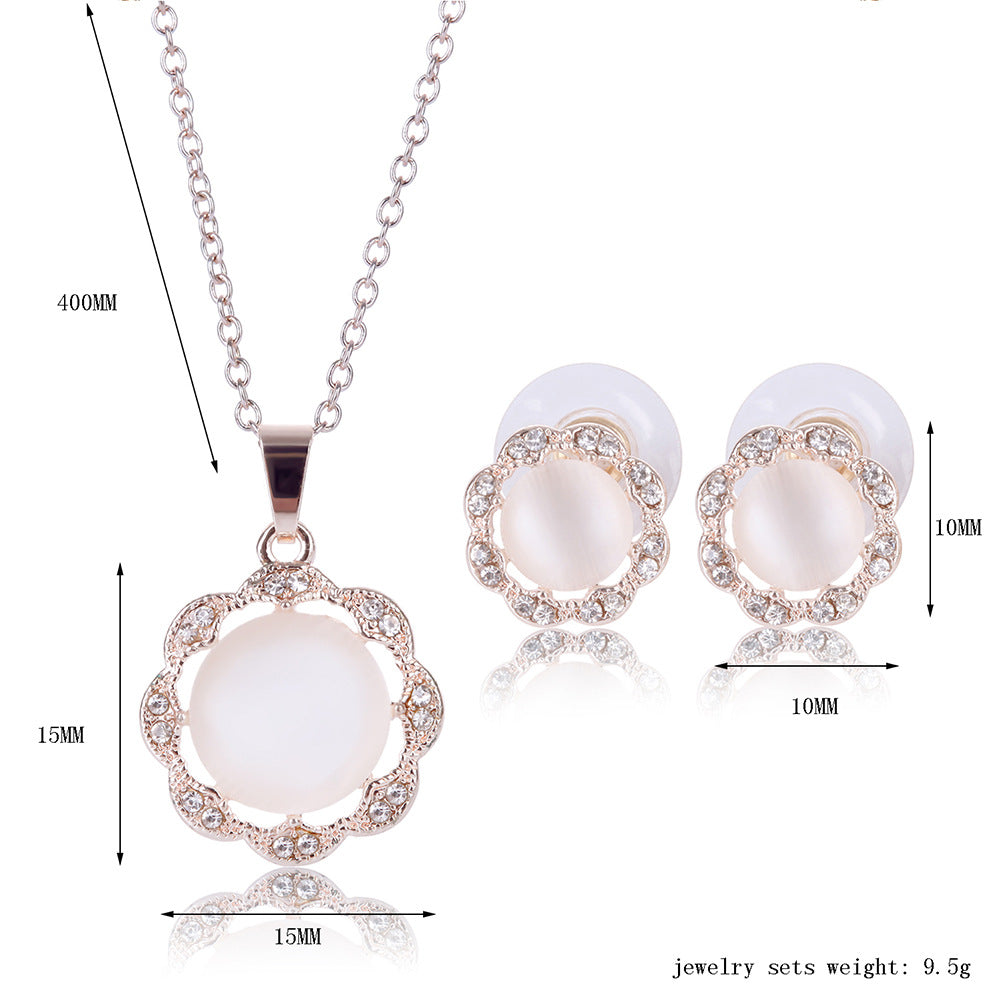 Jewelry set with necklace and earrings featuring white stones and gold accents, with measurements on a white background.