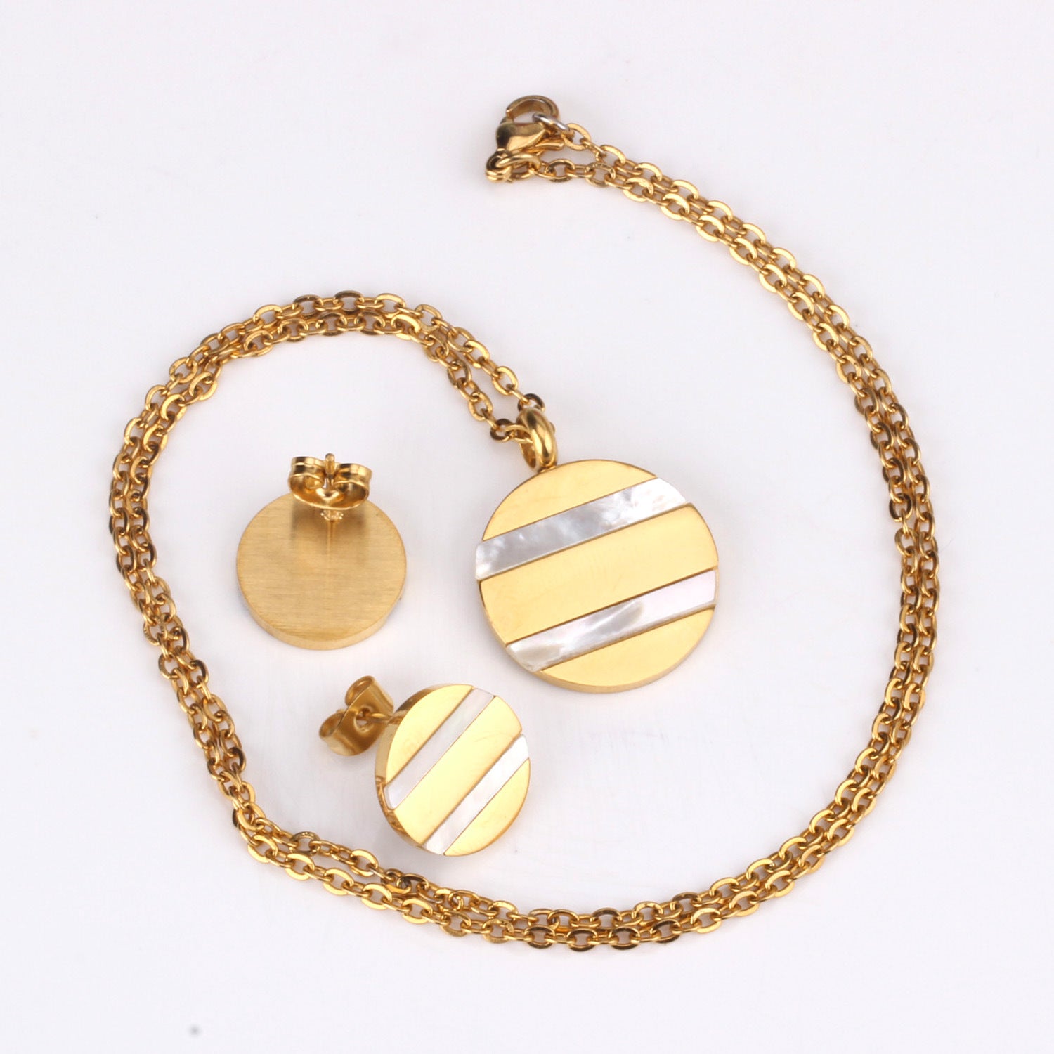 Gold necklace with circular pendants on a white background