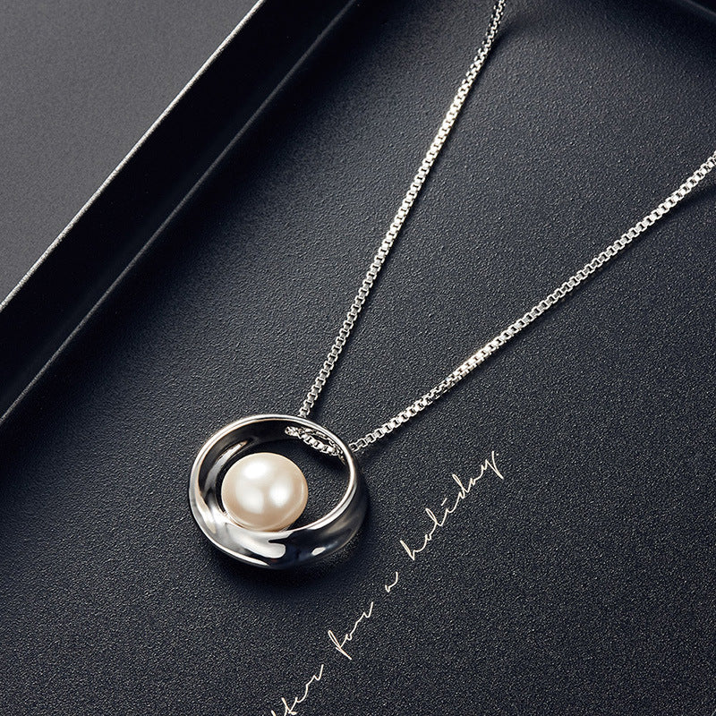 Pearl necklace on a dark surface with 'Mother's Day' text