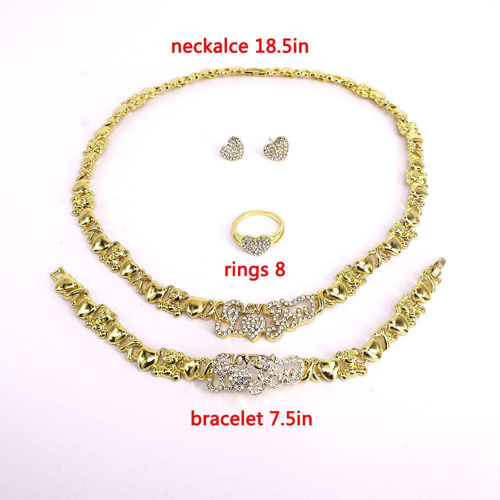 Gold jewelry set with necklace, bracelet, ring, and earrings on a white background.