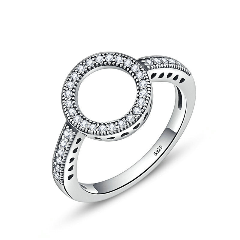 Silver ring with diamond accents on a white background