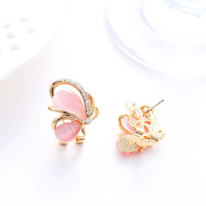 Pair of pink and gold earrings on a white background