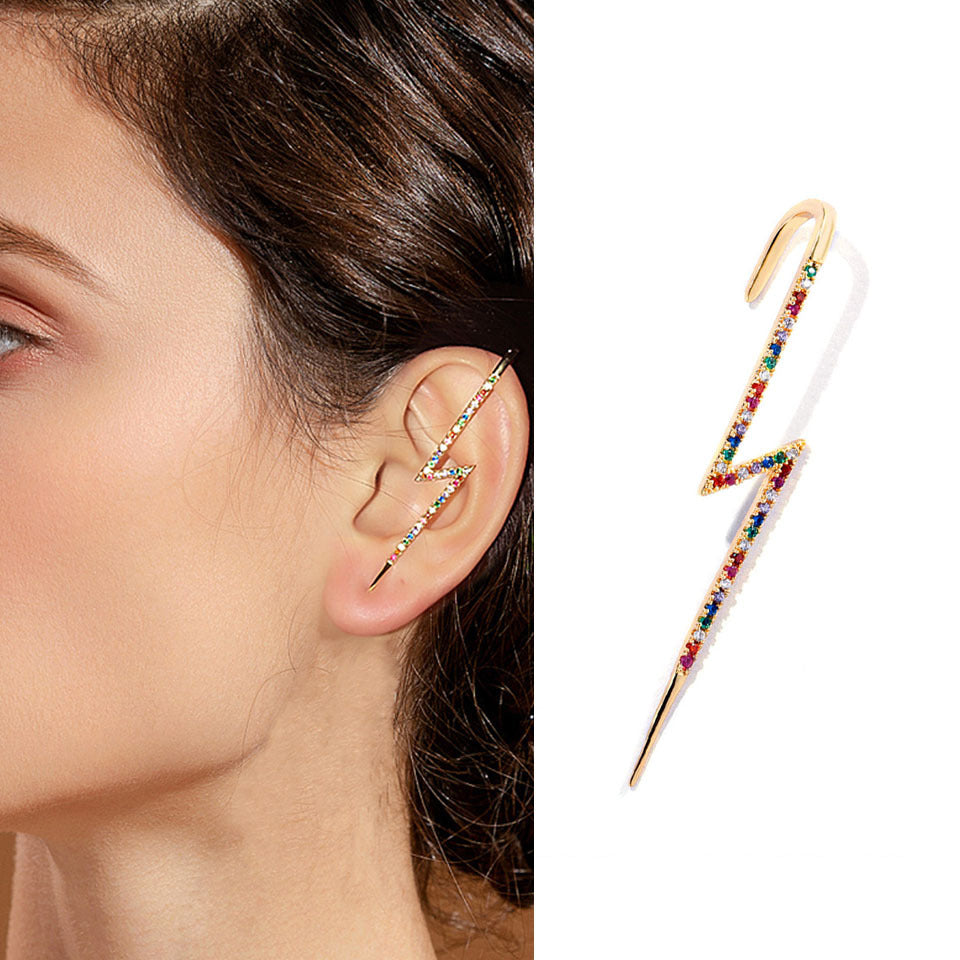Multicolored lightning bolt earring worn by a model on a white background