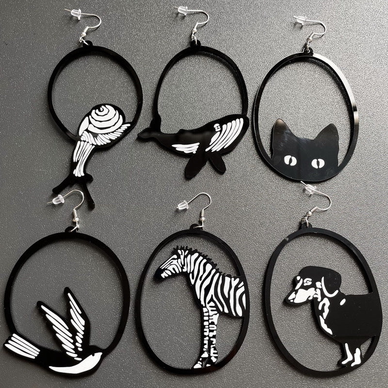 Set of earrings with animal silhouettes on a gray background