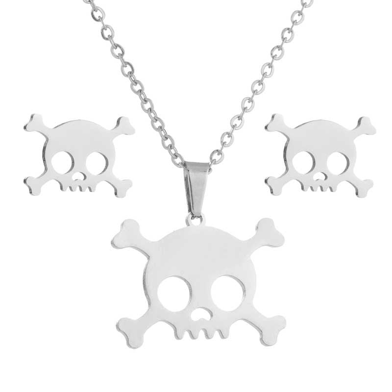 Silver skull necklace and earrings set on a white background