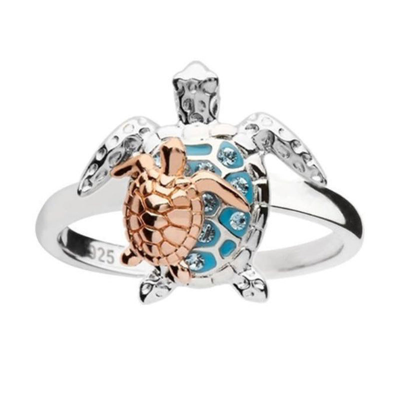 Tortoiseshell ring with rose gold and silver design on a white background