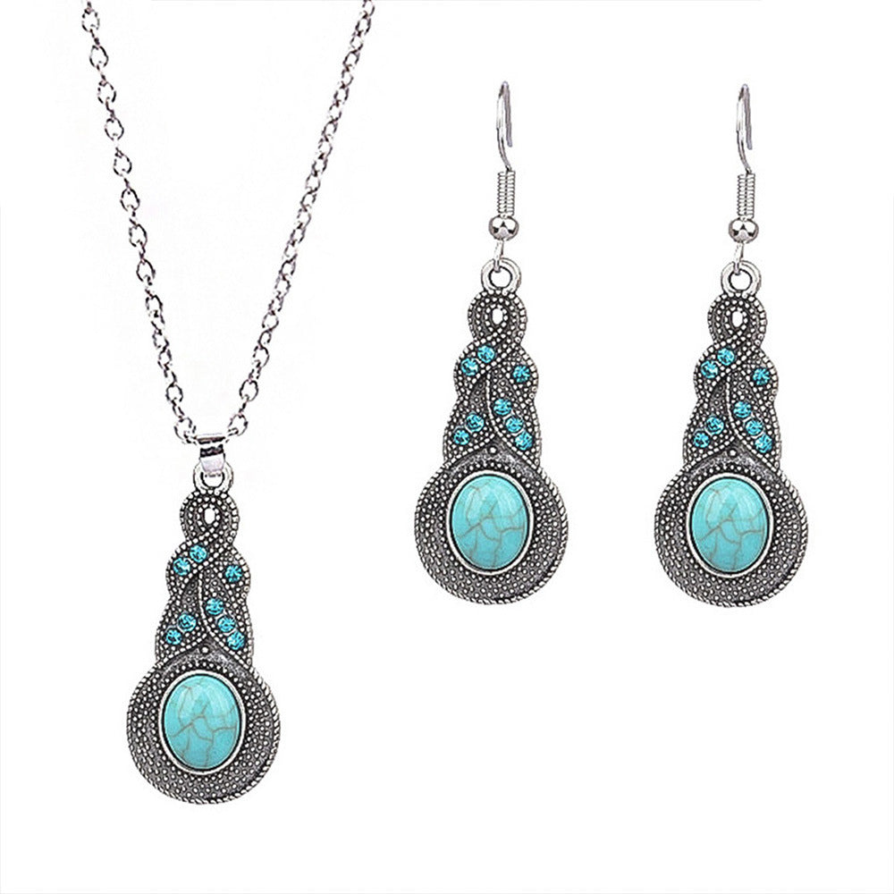 Jewelry set with necklace and earrings featuring turquoise stones on a white background