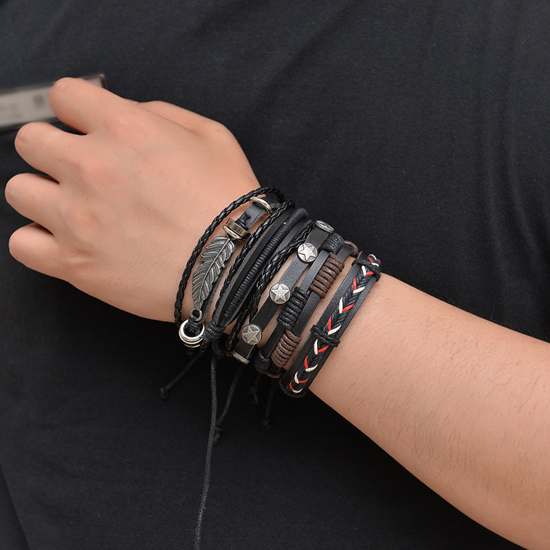 Multiple leather bracelets with various designs on a wrist against a black background