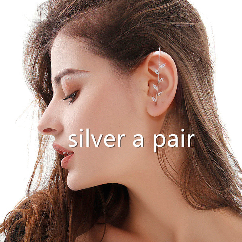 Close-up of a woman wearing an ear cuff with text 'silver a pair' on a white background