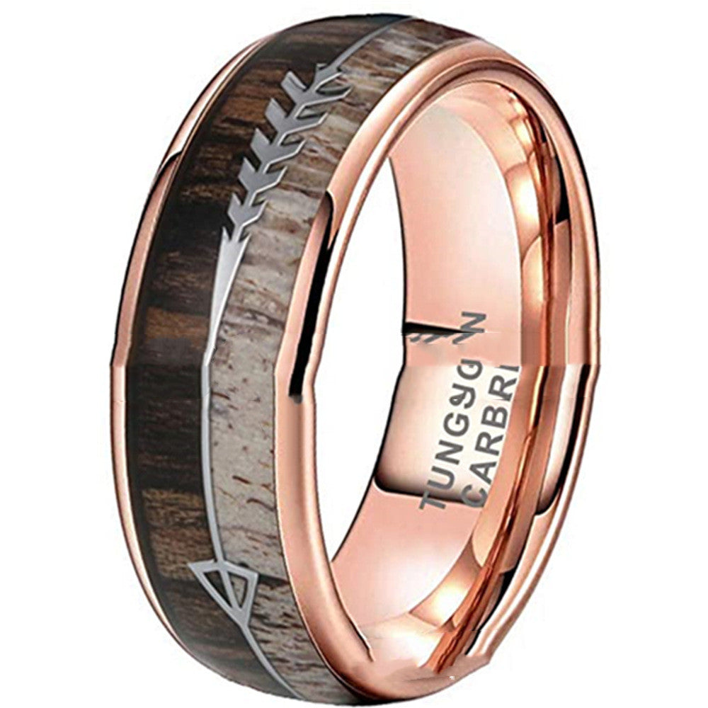 Rose gold ring with wooden inlay and engraved design on a white background