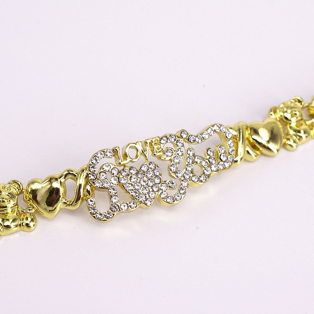Gold bracelet with heart designs and clear stones on a white background
