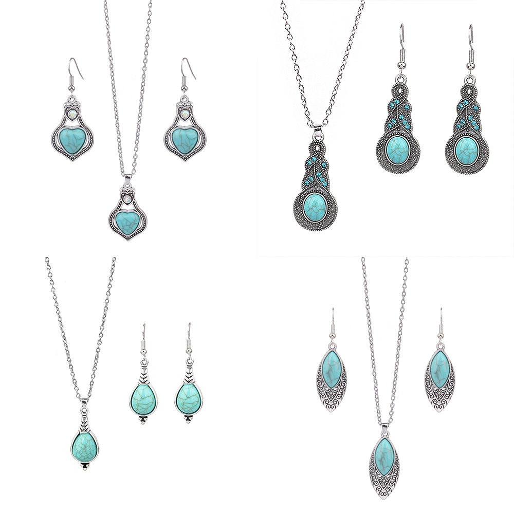 Jewelry set with turquoise stones and silver accents on a white background