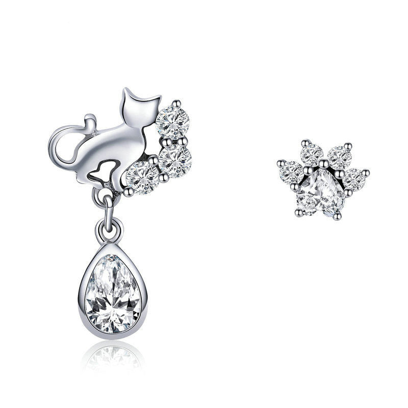 Silver earrings with clear gemstones on a white background