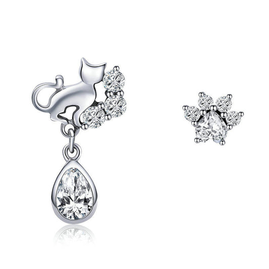 Silver earrings with clear gemstones on a white background
