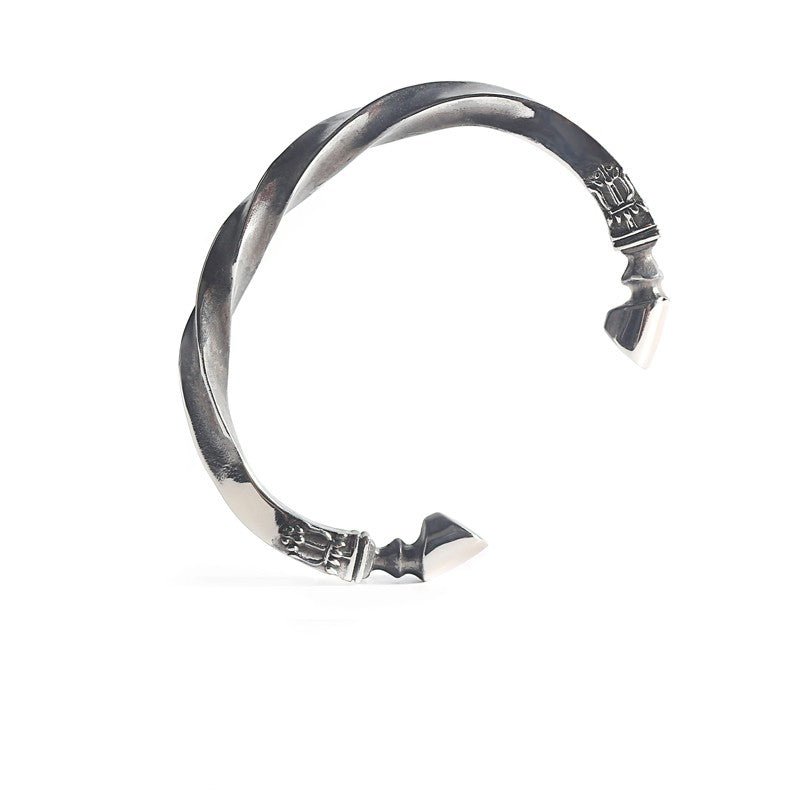 Silver twisted ring with decorative elements on a white background