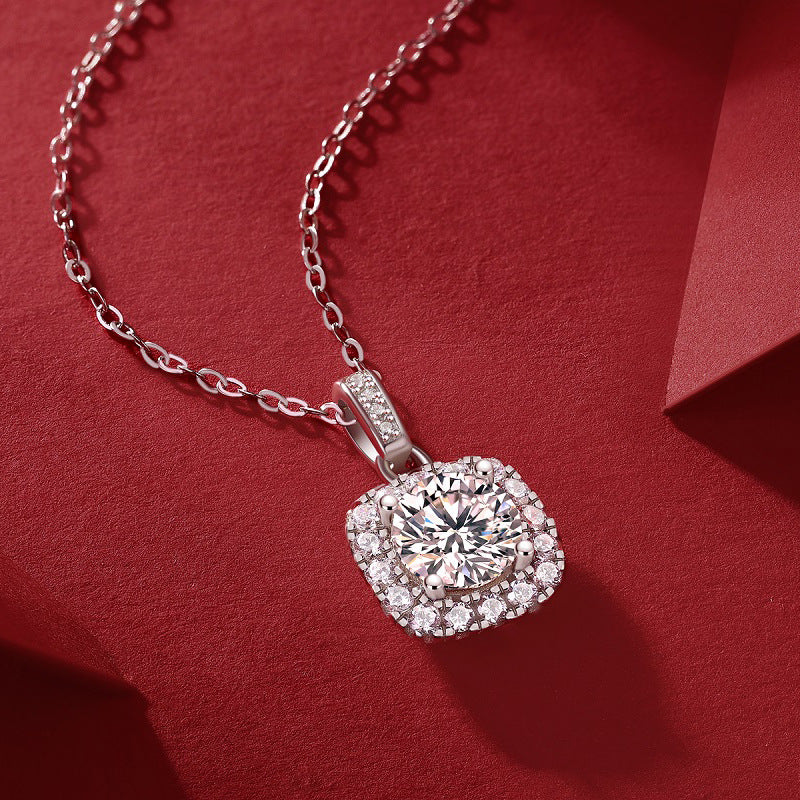 Silver necklace with a diamond pendant on a red background