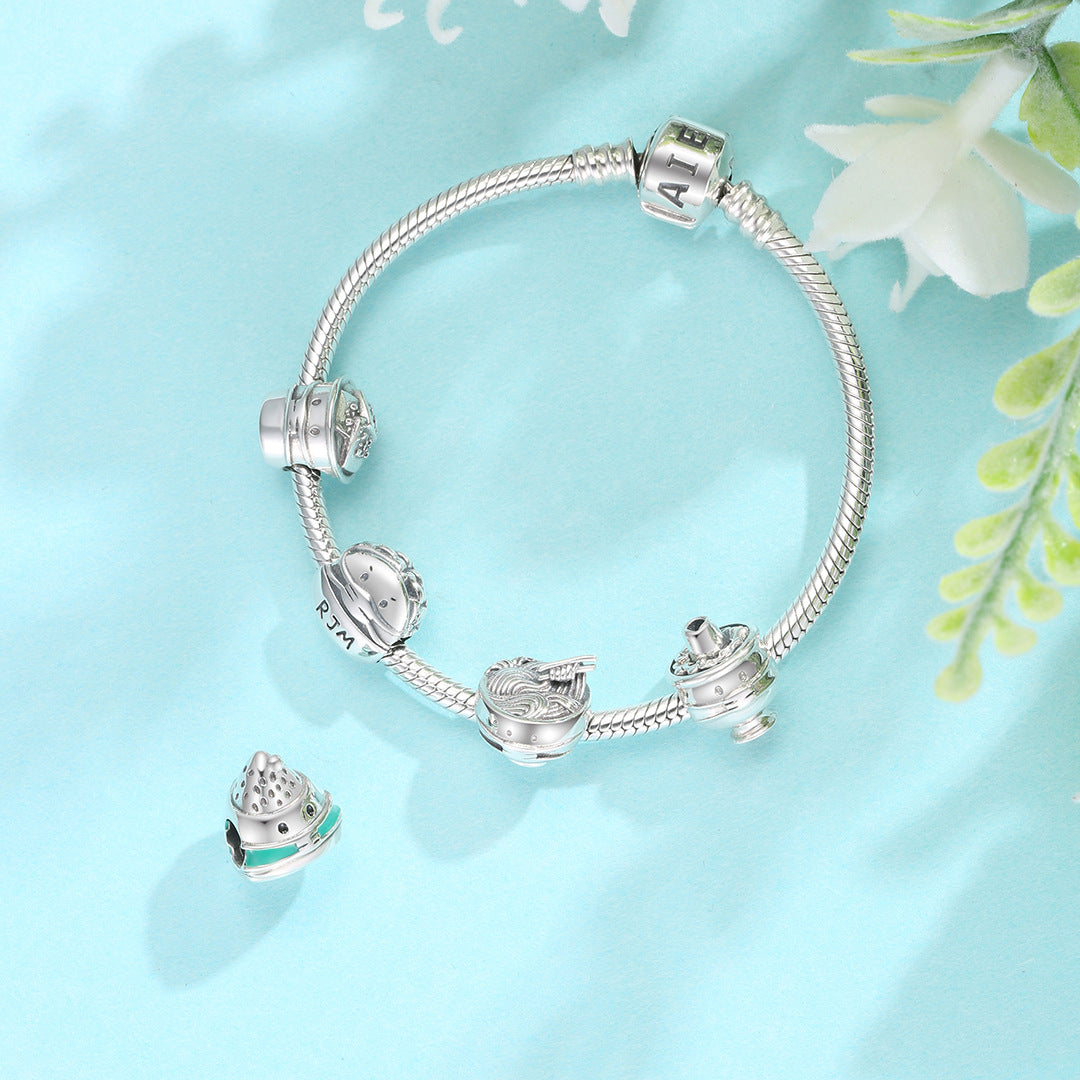 Silver bracelet with charms on a light blue background