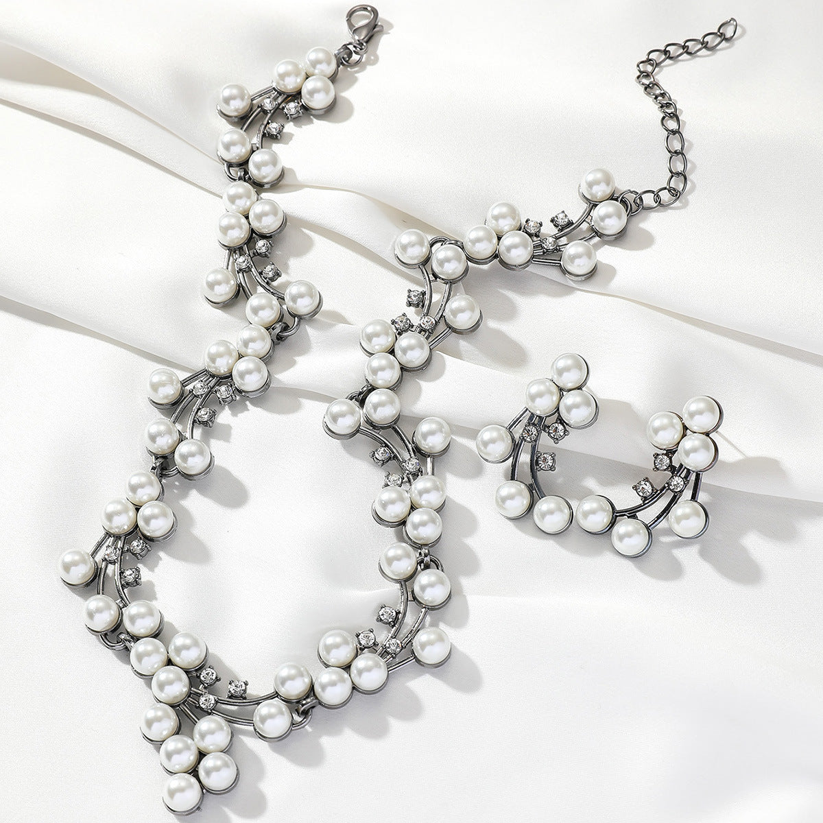 Pearl necklace with silver accents on a white background