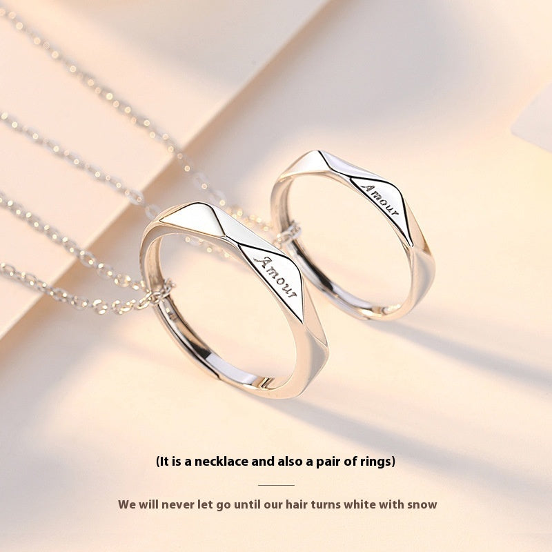 Silver necklace and ring set with 'Amour' engraving on a light background
