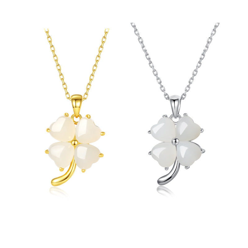 Two four-leaf clover pendants, one gold and one silver, on white backgrounds.