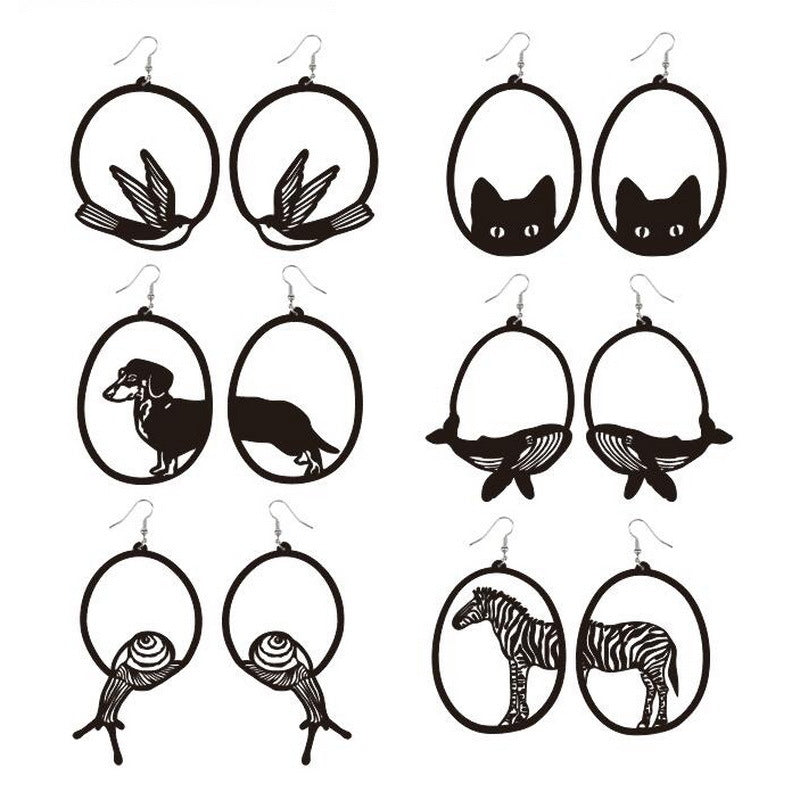 Set of black and white animal silhouette earrings on a white background