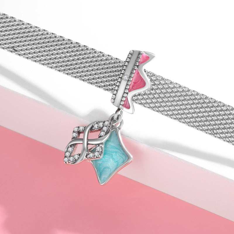 Silver bracelet with a turquoise charm on a pink and white background