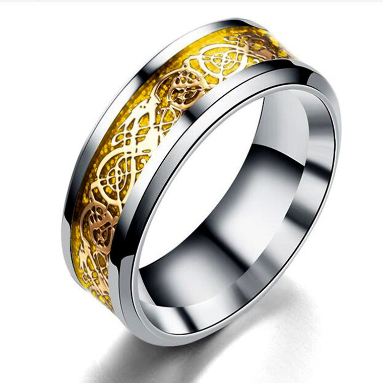 Silver ring with gold Celtic knot design on a white background