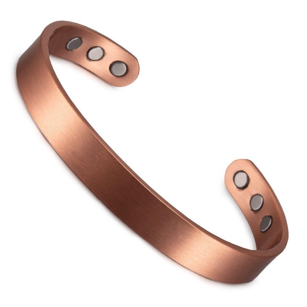 Copper bracelet with magnetic stones on a white background