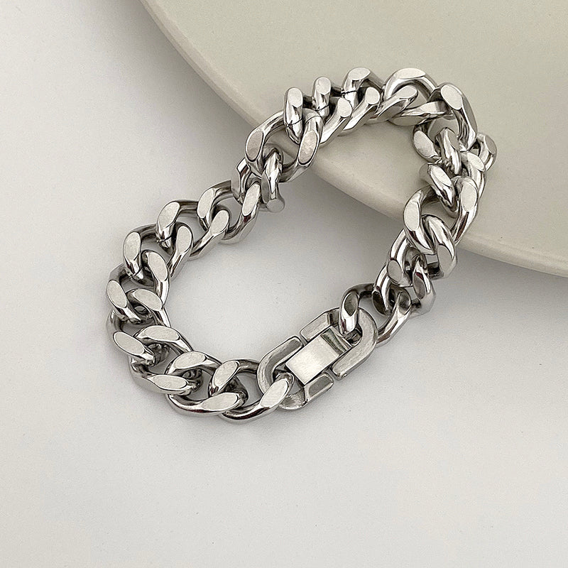 Silver chain bracelet on a light gray background
