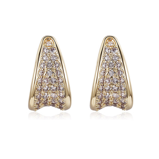 Gold earrings with diamond accents on a white background