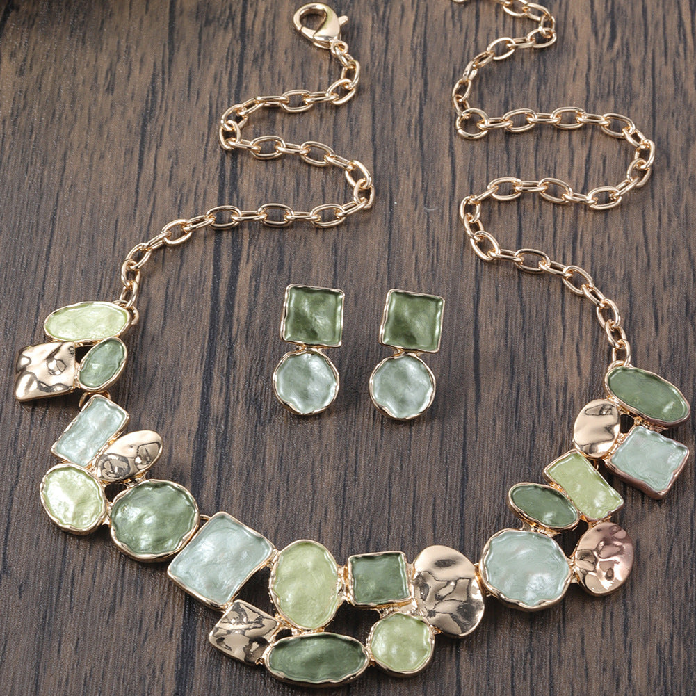 Jewelry set with necklace and earrings on a wooden surface