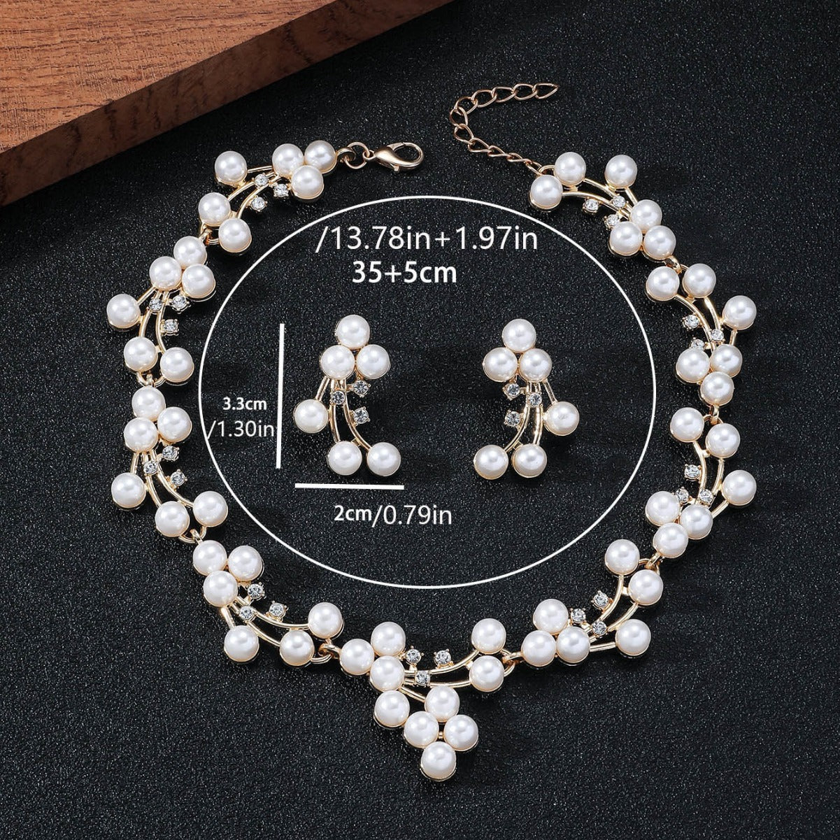 Pearl necklace and earrings set with measurements on a black background