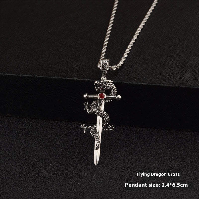 Silver pendant with dragon design and sword on a black background