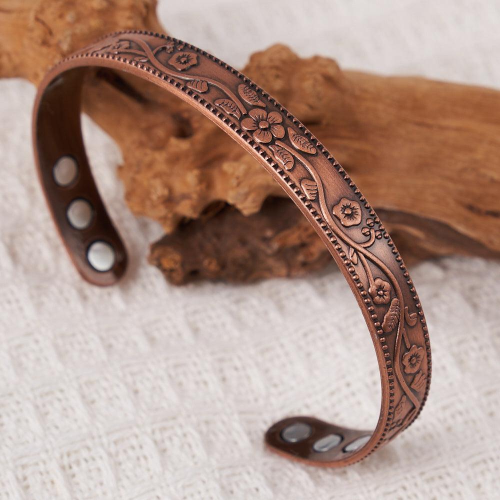 Decorative copper bracelet on a textured surface