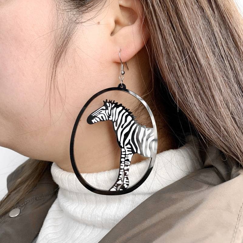 Earring with zebra design worn by a person
