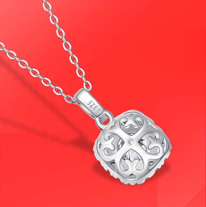 Silver necklace with a detailed pendant on a red background