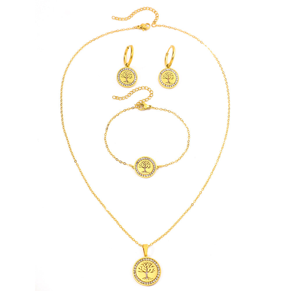 Gold jewelry set with necklace, bracelet, and earrings on a white background