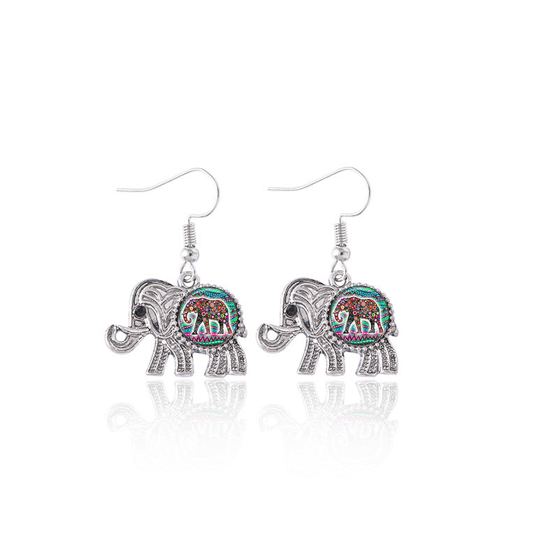 Pair of elephant-shaped earrings with colorful designs on a white background