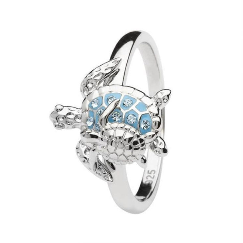 Silver ring with blue gemstones on a white background