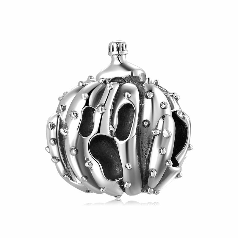 Silver pumpkin-shaped decorative charm on a white background