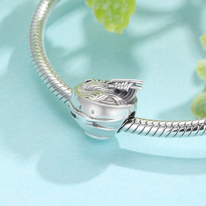 Silver bracelet with a detailed clasp on a light blue background