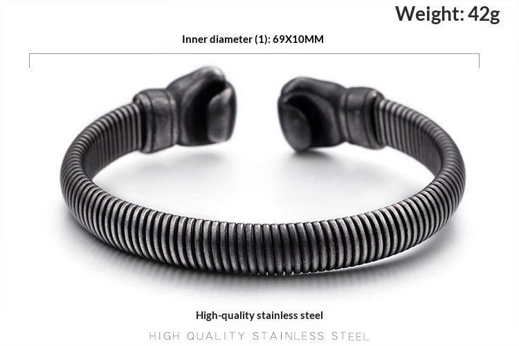 A dark metallic split cuff bracelet with a textured, ribbed exterior and rounded end caps, shown on a white background with text overlays detailing its dimensions, weight, and material.