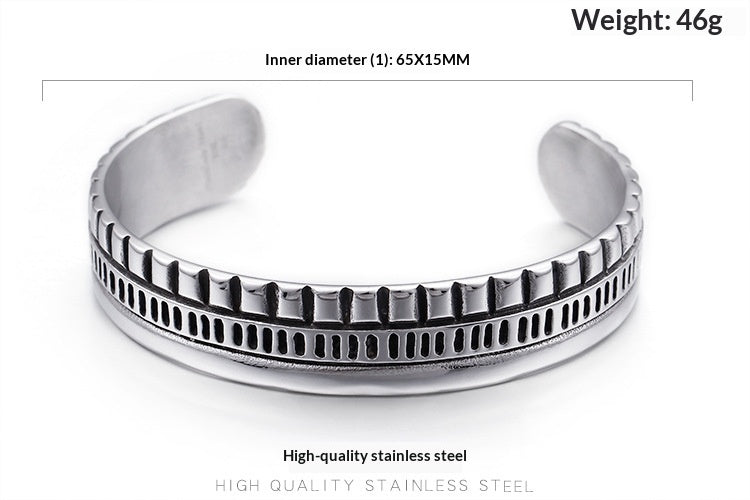 A silver-toned stainless steel cuff bracelet with a textured, ridged outer band, shown on a white background with text overlays detailing its inner diameter and weight.