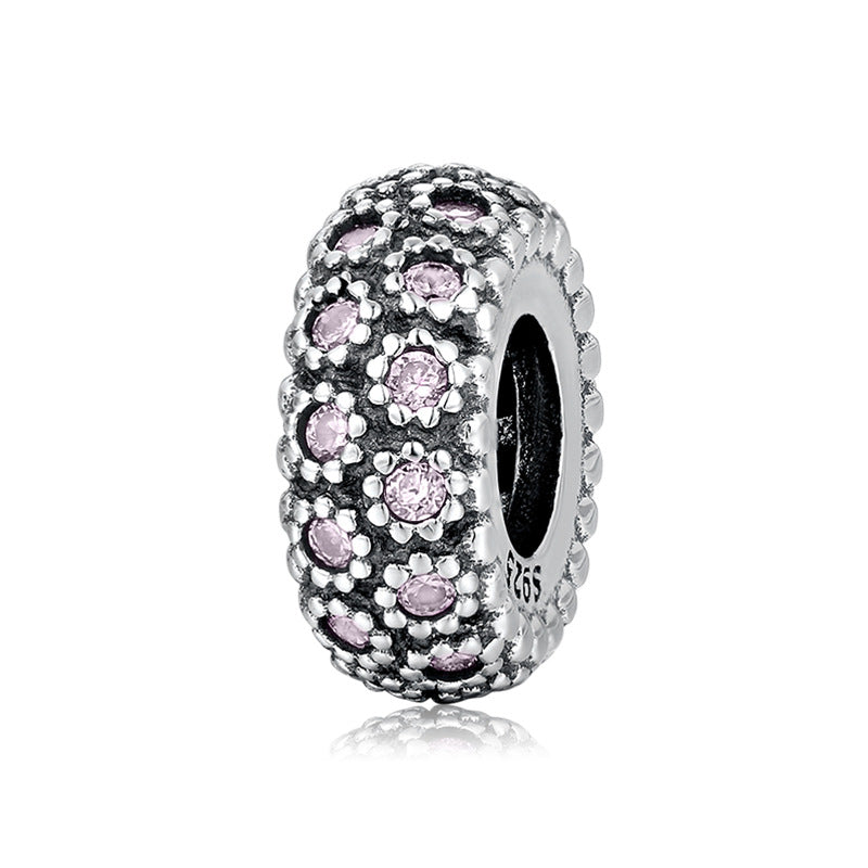 Silver charm with pink stones on a white background