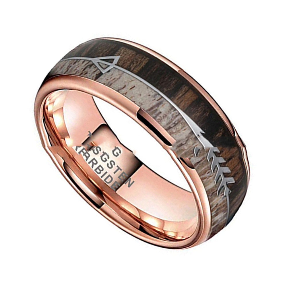Rose gold ring with wooden inlay and engraved text on a white background