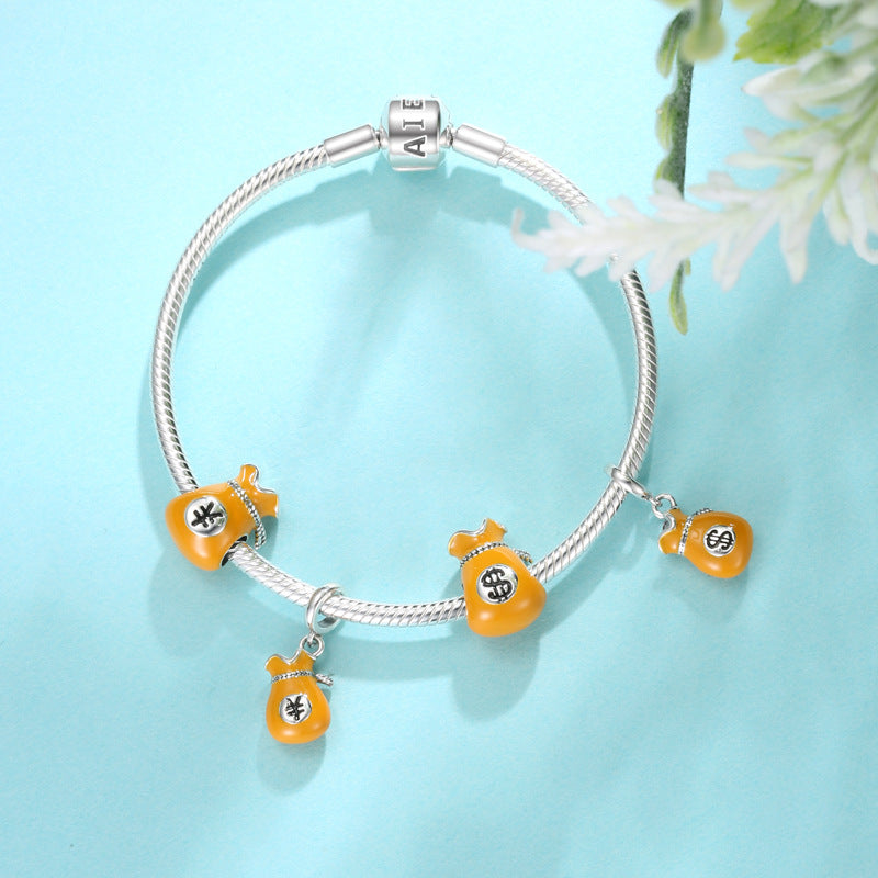 Bracelet with orange and silver charms on a light blue background