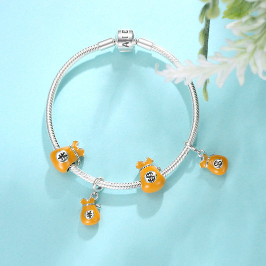 Bracelet with orange and silver charms on a light blue background