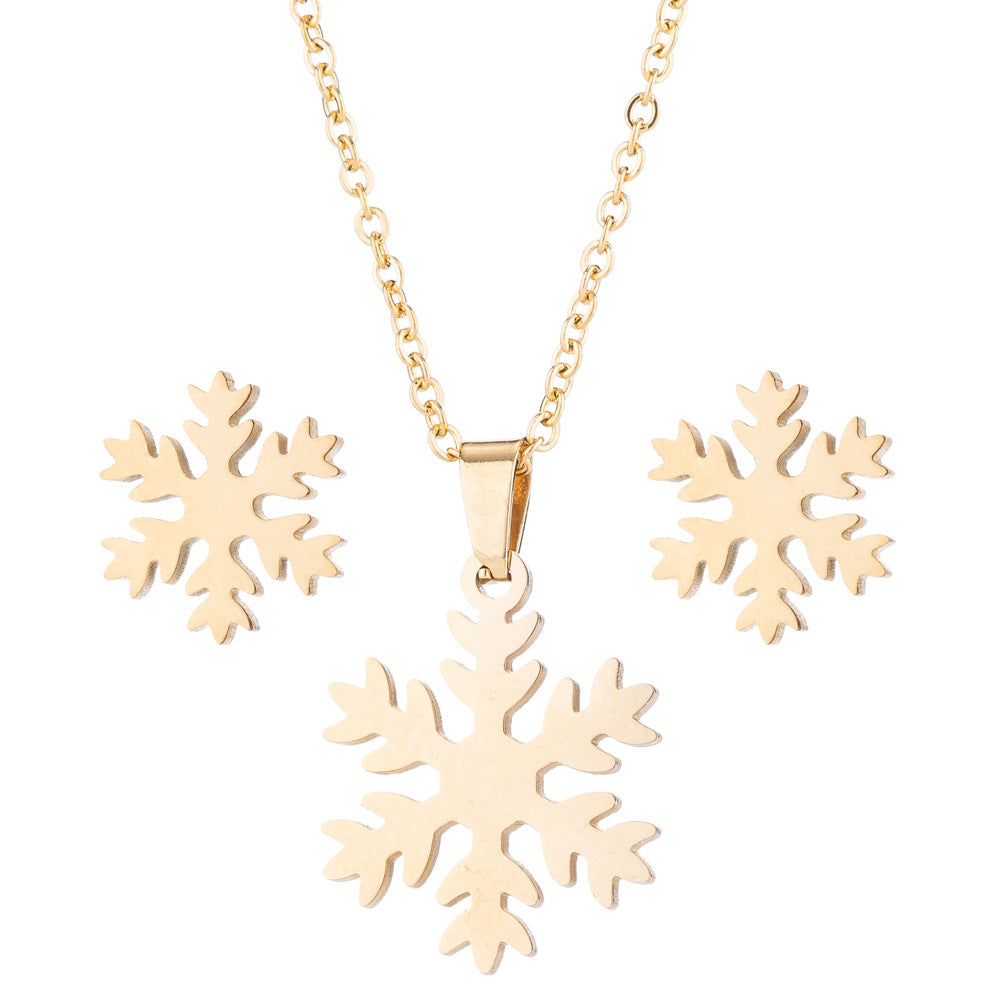 Gold snowflake necklace on a white background